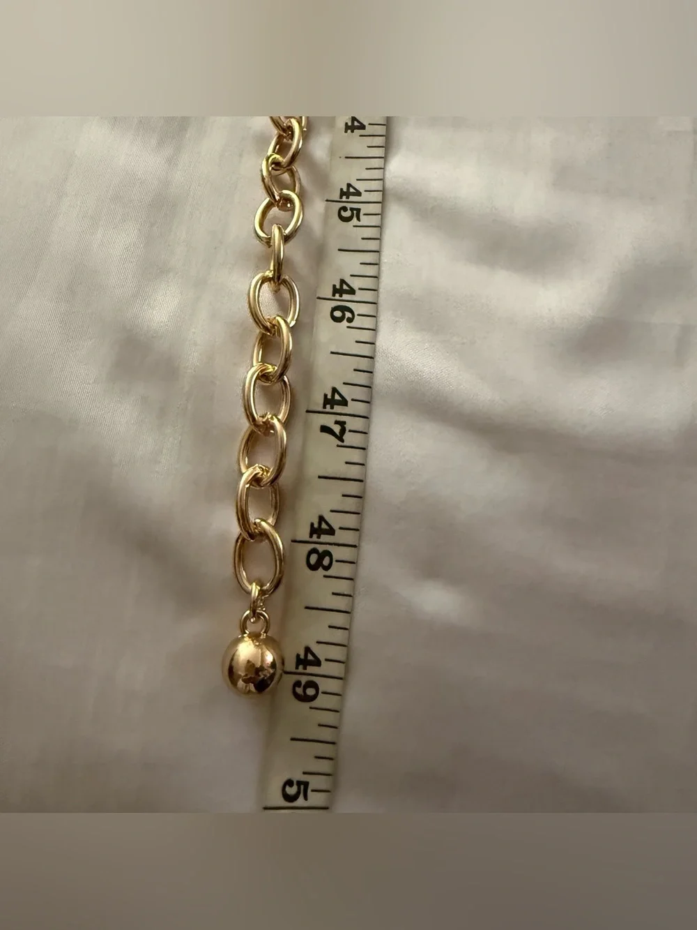 Gold tone metal chain belt with black plastic links